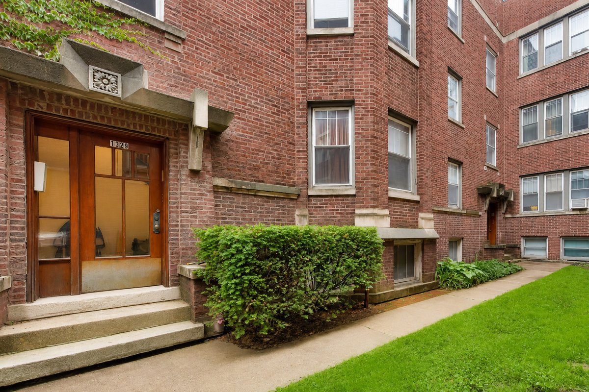 Brick apartment building entrance with front steps